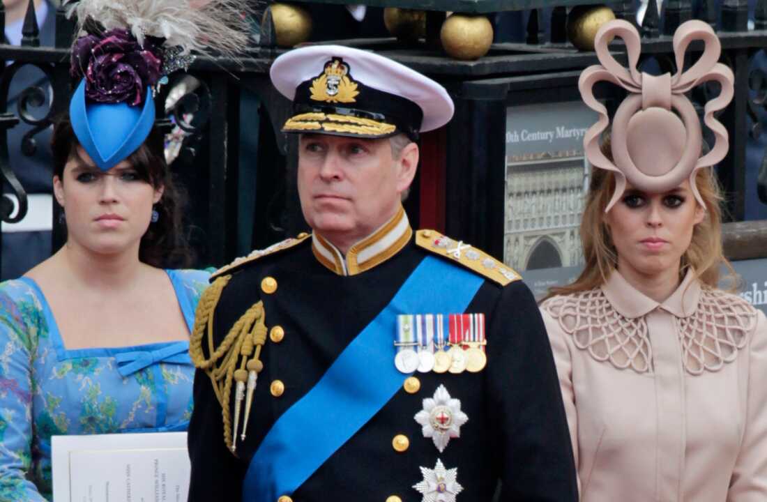 Britain's then-Prince Andrew (center) and his daughters Princess Eugenie (left) and Princess Beatrice leave Westminster Abbey after the wedding of Prince William to Catherine Middleton, in London, April 29, 2011.