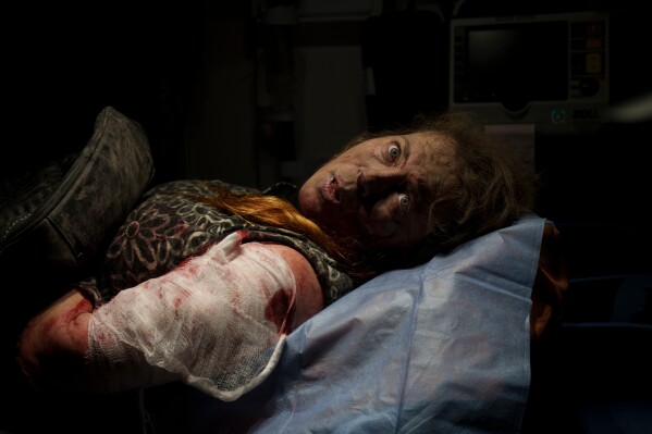 A person wounded in a Russian attack lies inside an ambulance before being taken to a hospital in Kherson, Ukraine, Thursday, Nov. 24, 2022. (AP Photo/Bernat Armangue, File)