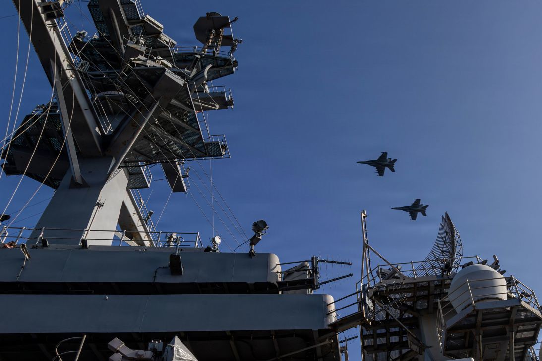 Two F/A-18E Super Hornets fly over Nimitz-class aircraft carrier USS Abraham Lincoln in the Arabian Sea, on February 12.