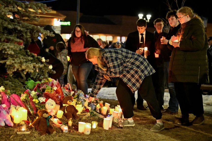 People lay flowers and light candles during a vigil in the town of Tumbler Ridge, British Columbia, Canada February 11, 2026. REUTERS/Jennifer Gauthier