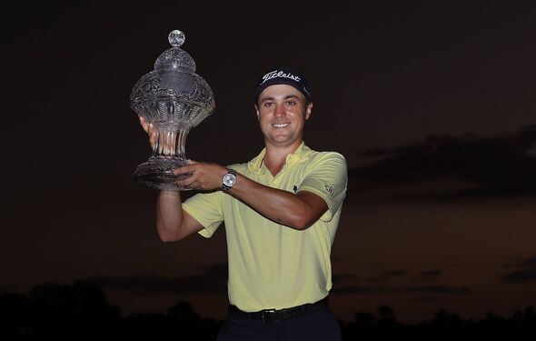 Justin Thomas poses with the trophy after winning The Honda Classic