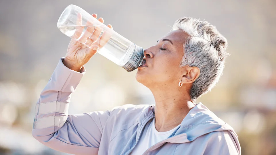 a senior woman drinking water