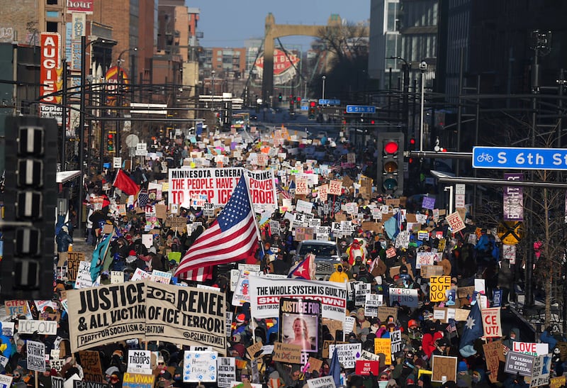 MINNEAPOLIS, MN. - JANUARY 2026: In sub-zero temperatures, marchers in downtown Minneapolis, Minn., on Friday, January 23, 2026, waved signs decrying ongoing immigration enforcement operations in the Twin Cities metro area, Operation Metro Surge. On Wednesday, January 7, 2026, Renee Nicole Good was shot and killed by an Immigration and Customs Enforcement (ICE) agent, Jonathan Ross, during a confrontation between federal agents and protesters in south Minneapolis.