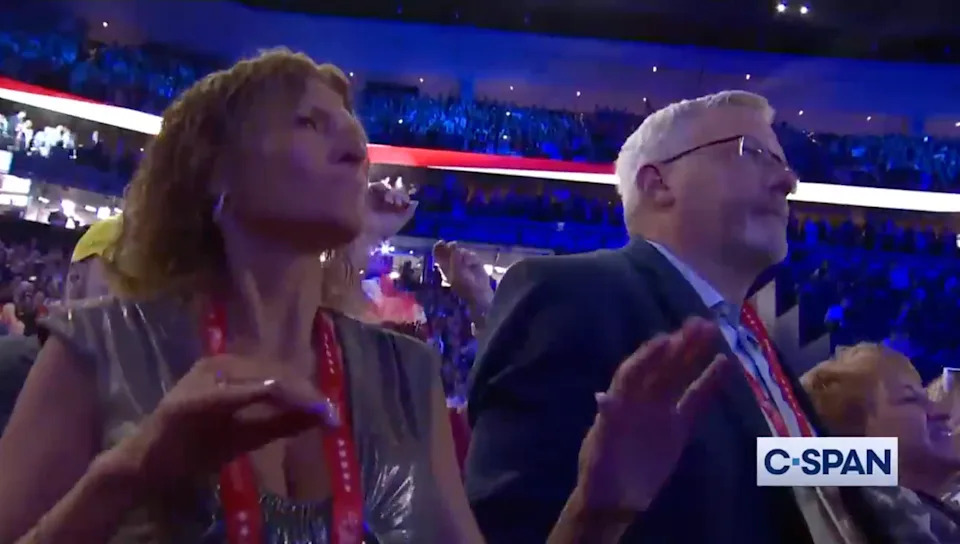 People at a crowded indoor event, wearing formal attire, appear engaged and attentive. C-SPAN logo displayed