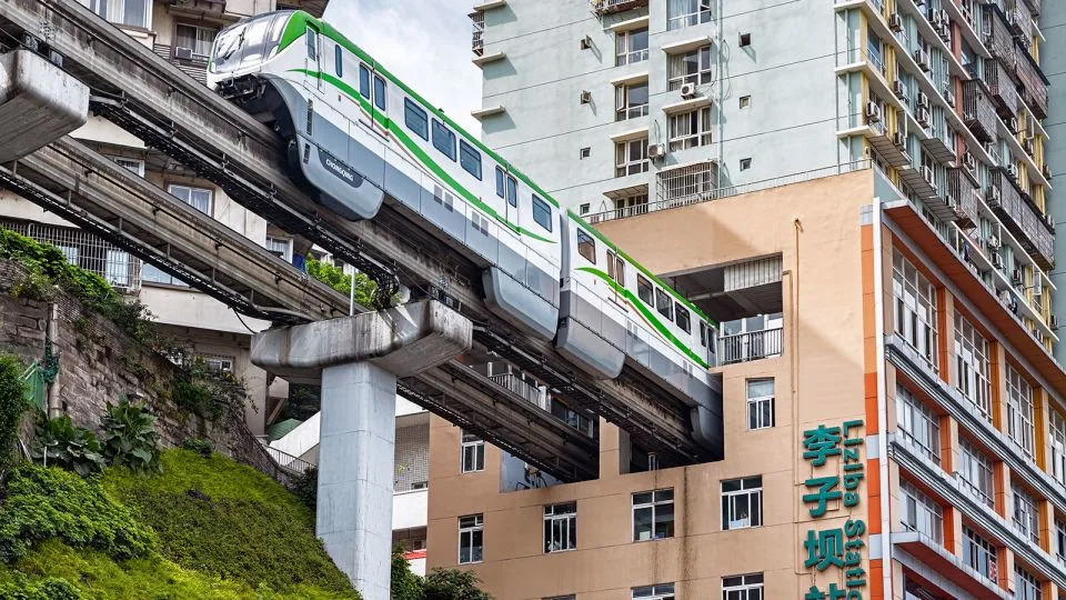Chongqing Rail Transit Line 2 passes through Liziba Station, where the track runs directly through a residential building. - Sky_Blue/iStock/Getty Images