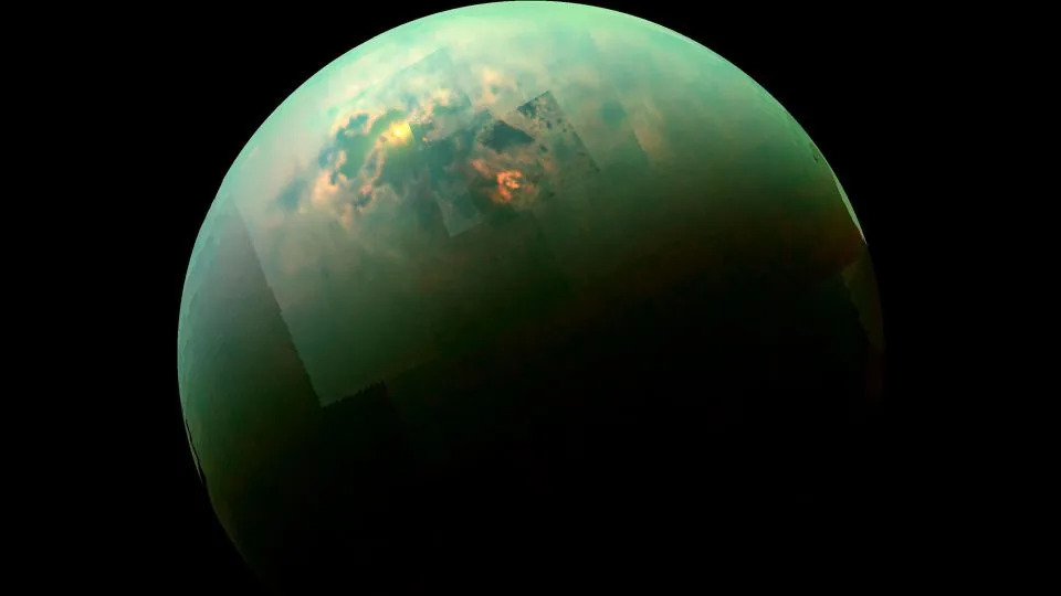 A view of Titan from Cassini, with the sun illuminating  the moon's north polar seas. - NASA/JPL-Caltech/University of Arizona/University of Idaho