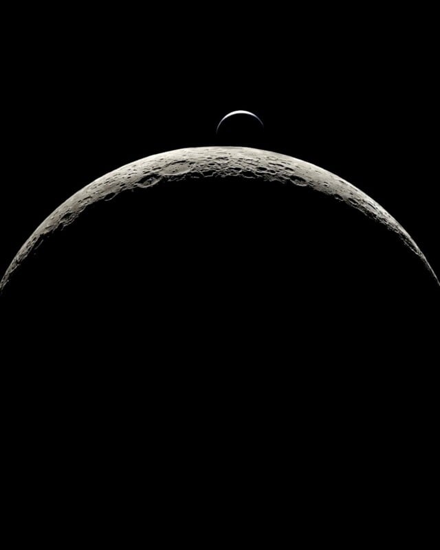 The crescent Earth rises above the curved, cratered surface of the Moon against a black space background.