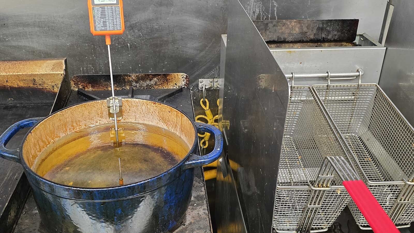 Getting the perfect temperature is crucial to the right texture for French fries. The pot on the left was used for the vegetable oil, along with the thermometer ensuring correct temperature. The baskets on the right were for the beef tallow oil in the fryer.