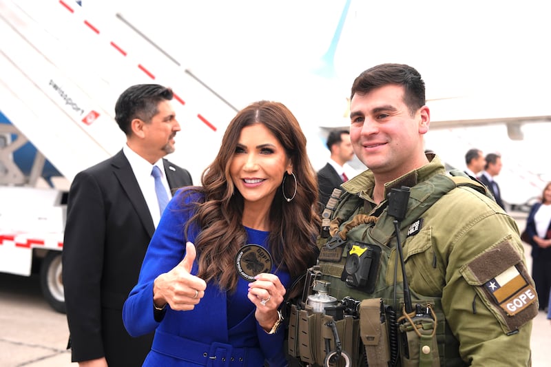 U.S. Homeland Security Secretary Kristi Noem poses for photos with a member of the Chilean special operations police (GOPE)