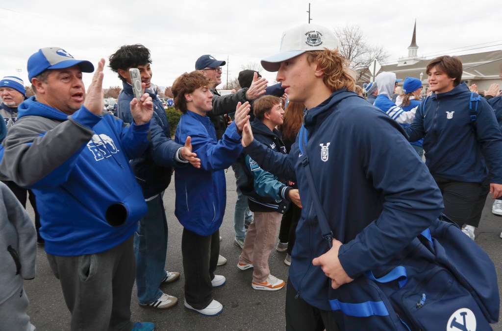 BYU players and fans greeting each other before a game against UCF.