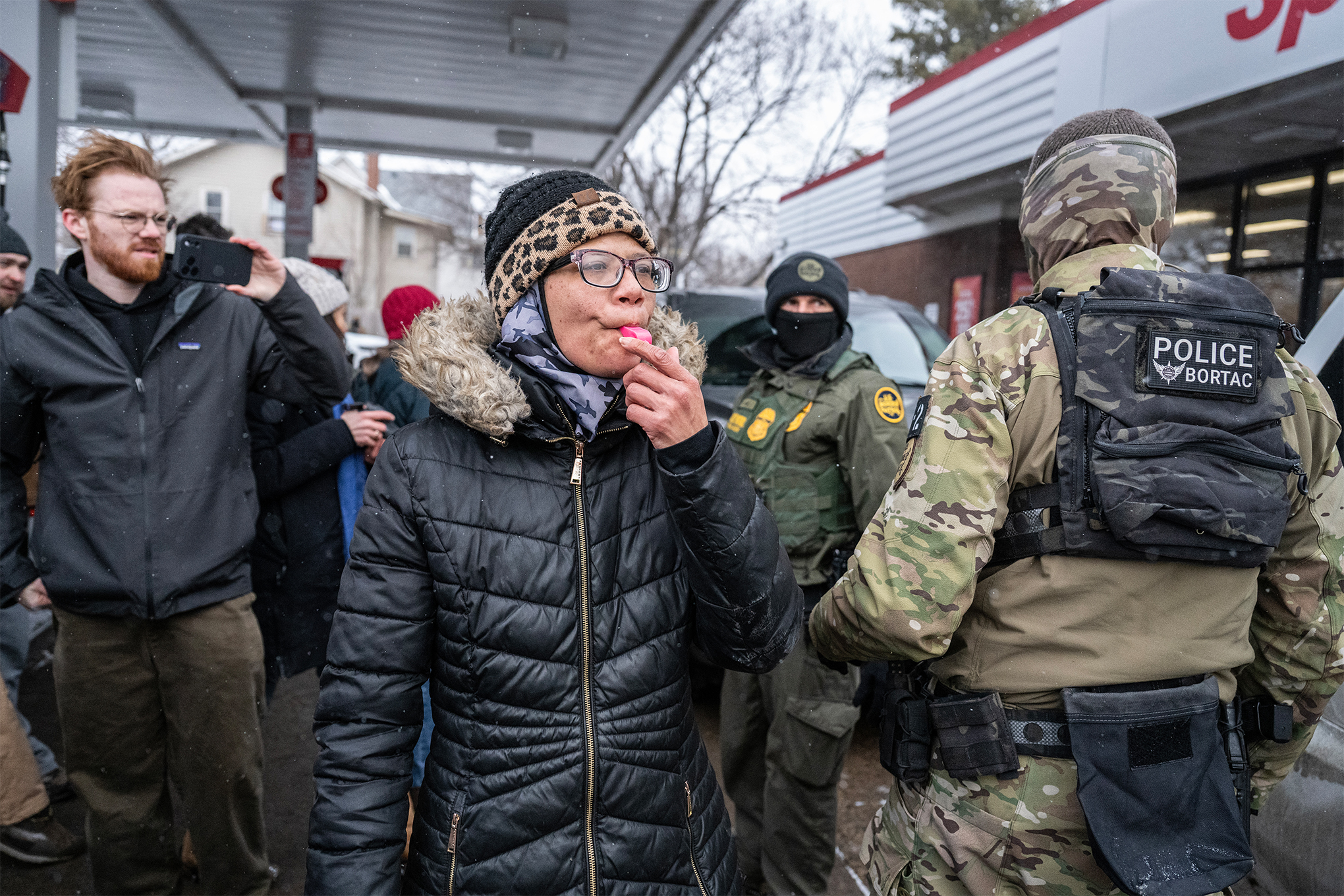 A woman blows her whistle at US Border Patrol agents at a gas station in Minneapolis, Minnesota, on January 21st.