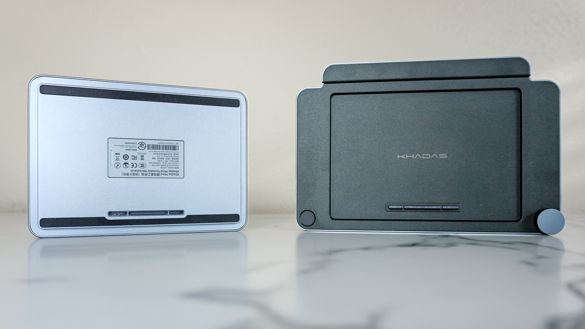 The Khadas Mind 2S seen from its underside next to the Khadas Mind Dock accessory