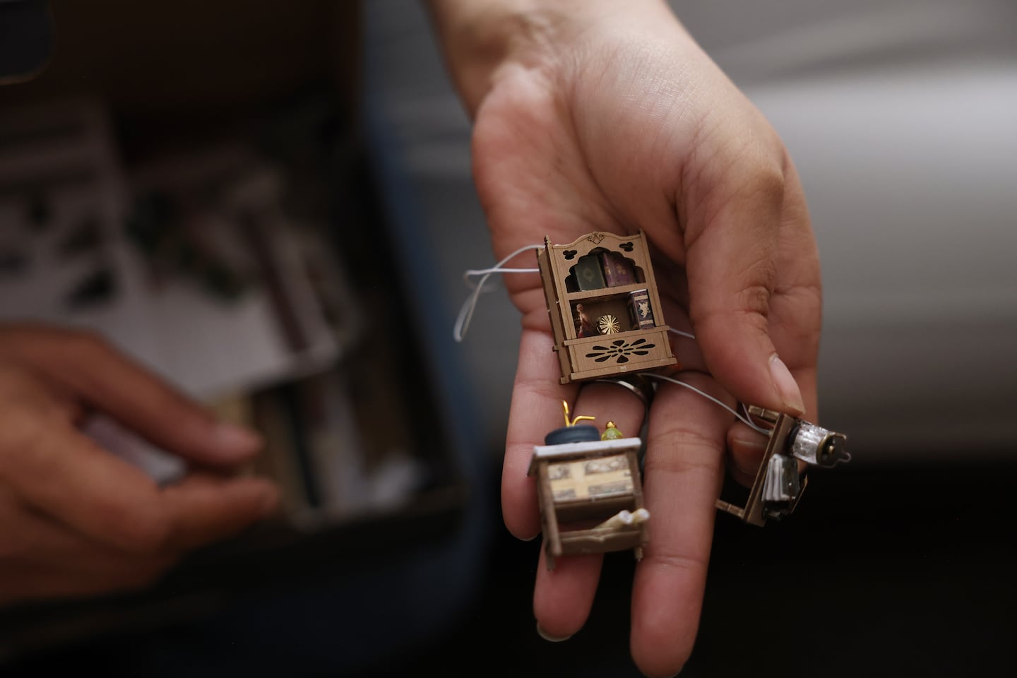 Gina Roberts showed off the small pieces she had assembled for one of her model homes, a cathartic hobby that helps center her mind.