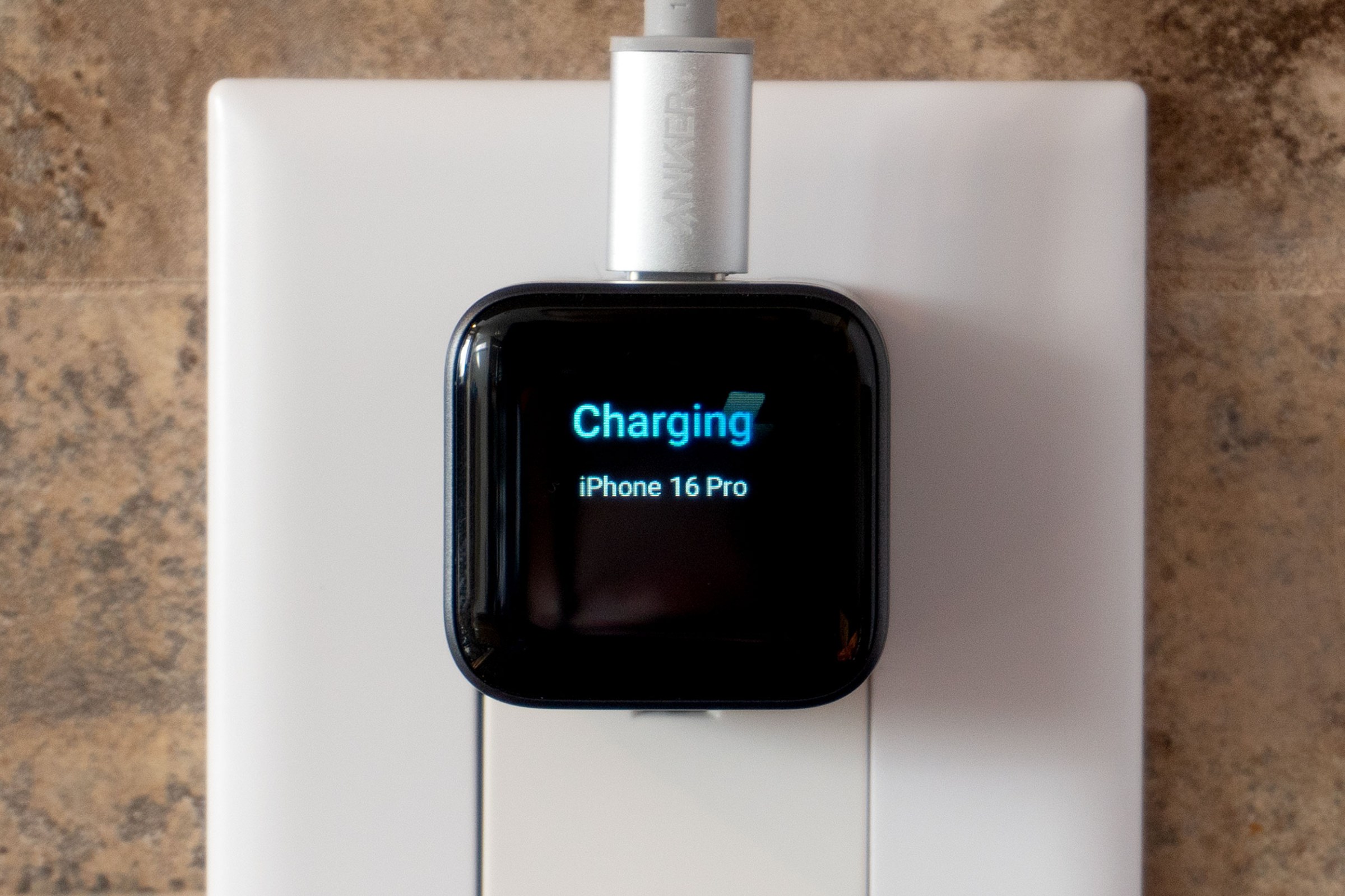A closeup of the screen on the Anker Nano charger plugged into a wall outlet.