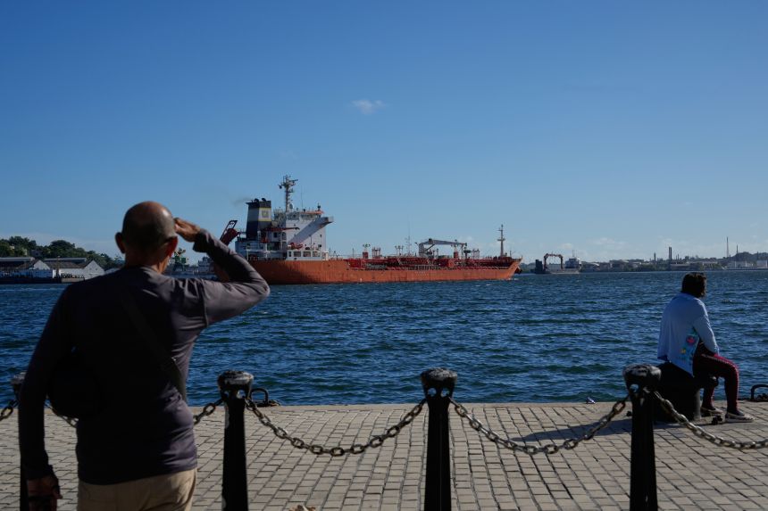 People watch the oil tanker Ocean Mariner, Monrovia, arrive to the bay in Havana, Cuba, on January 9, 2026.
