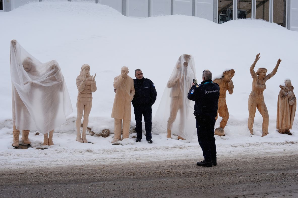 A person poses for a photo with statues at the biathlon venue on February 5.