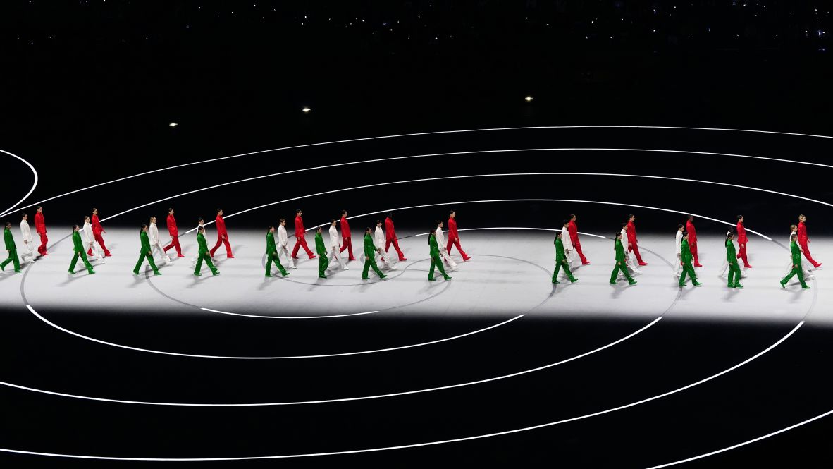 Performers wear the colors of Italy's flag during the opening ceremony.