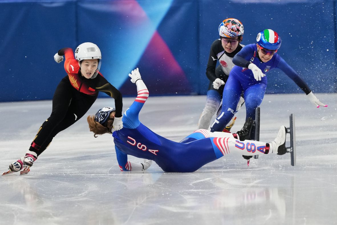 The United States' Corinne Stoddard wipes out as Wang Xinran of China moves past her to win the 500-meter short track event on February 10.
