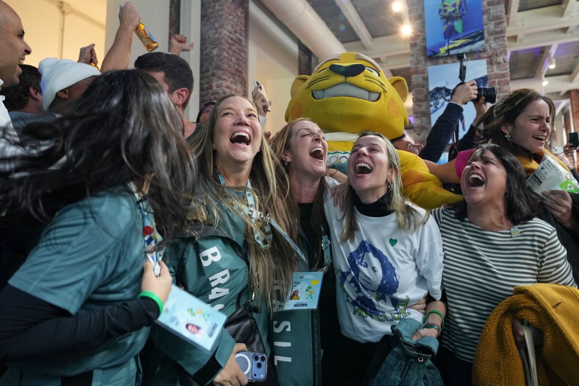 Supporters of Brazil's Lucas Pinheiro Braathen react as he wins the men's giant slalom on February 14..
