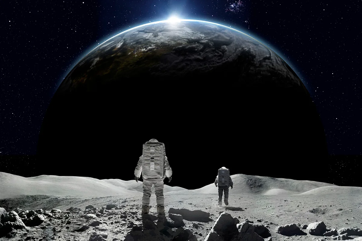 Artist's impression of astronauts on the Moon looking at Earth. Credit: Getty / Peppo