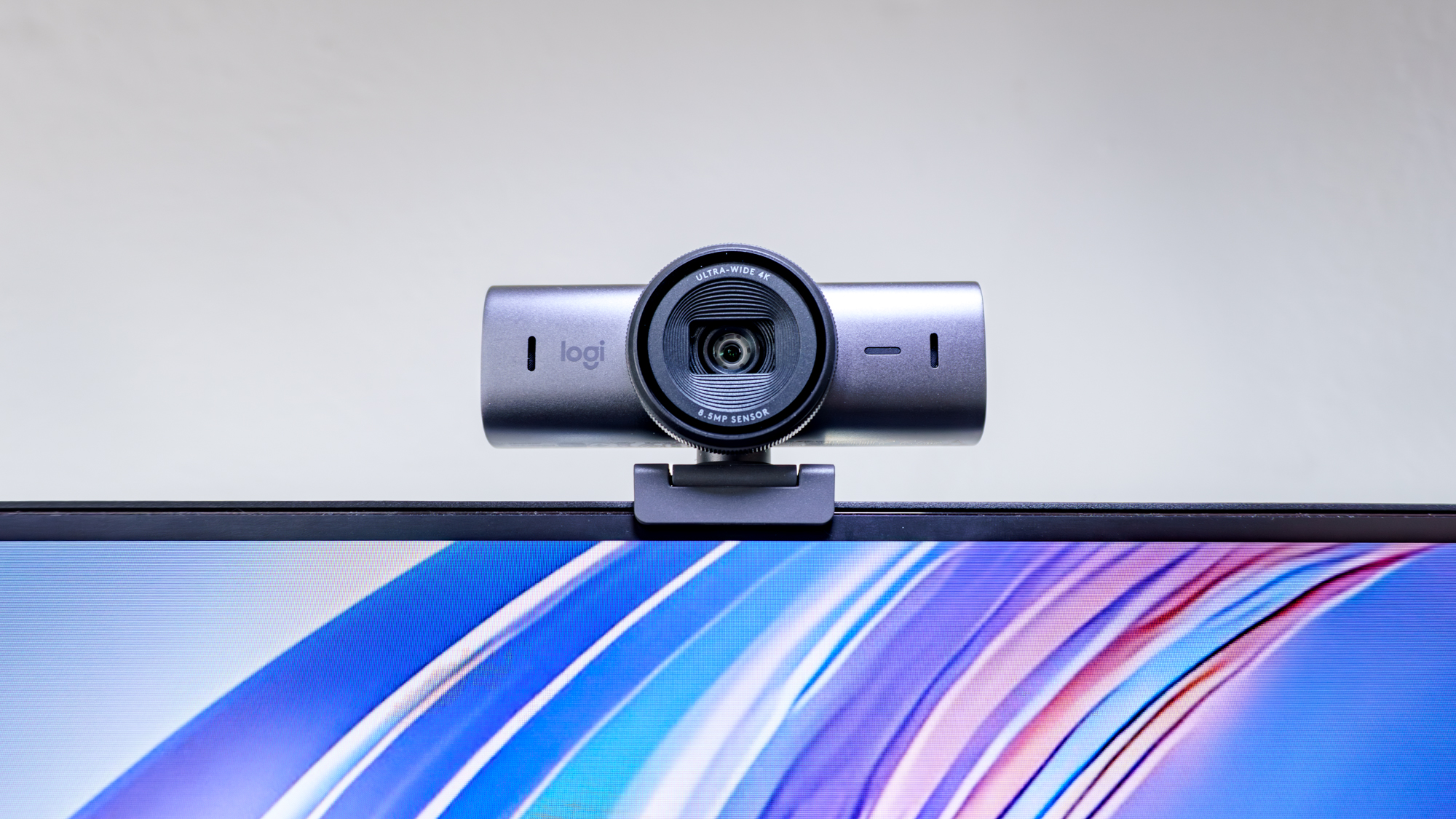 The Logitech MX Brio webcam perched on top of a display