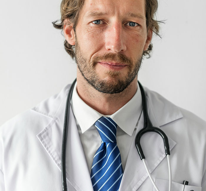 Close-up of a serious male doctor wearing a white coat and stethoscope, representing weirdly hilarious images for improving your feed.