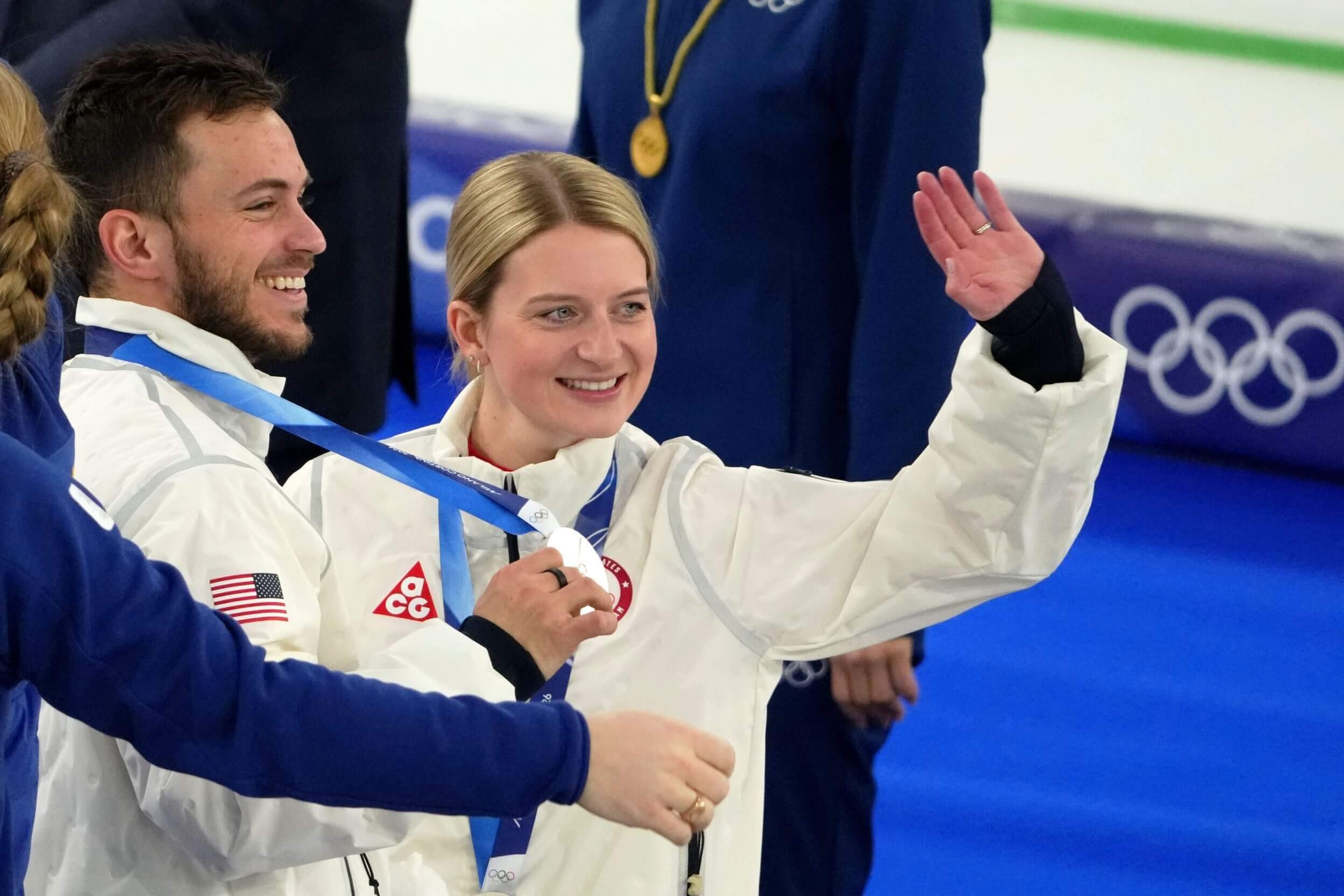 Silver medalists Korey Dropkin, left, and Cory Thiesse of the United States wave during the medal ceremony.