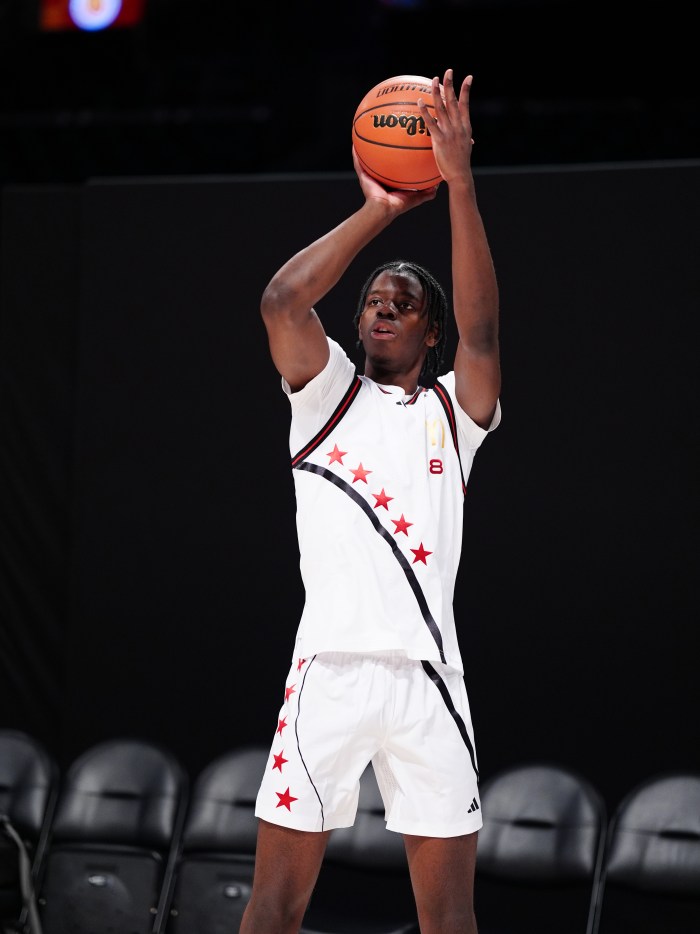 Caleb Wilson, wearing his McDonald's All-American jersey, shoots during warmups.