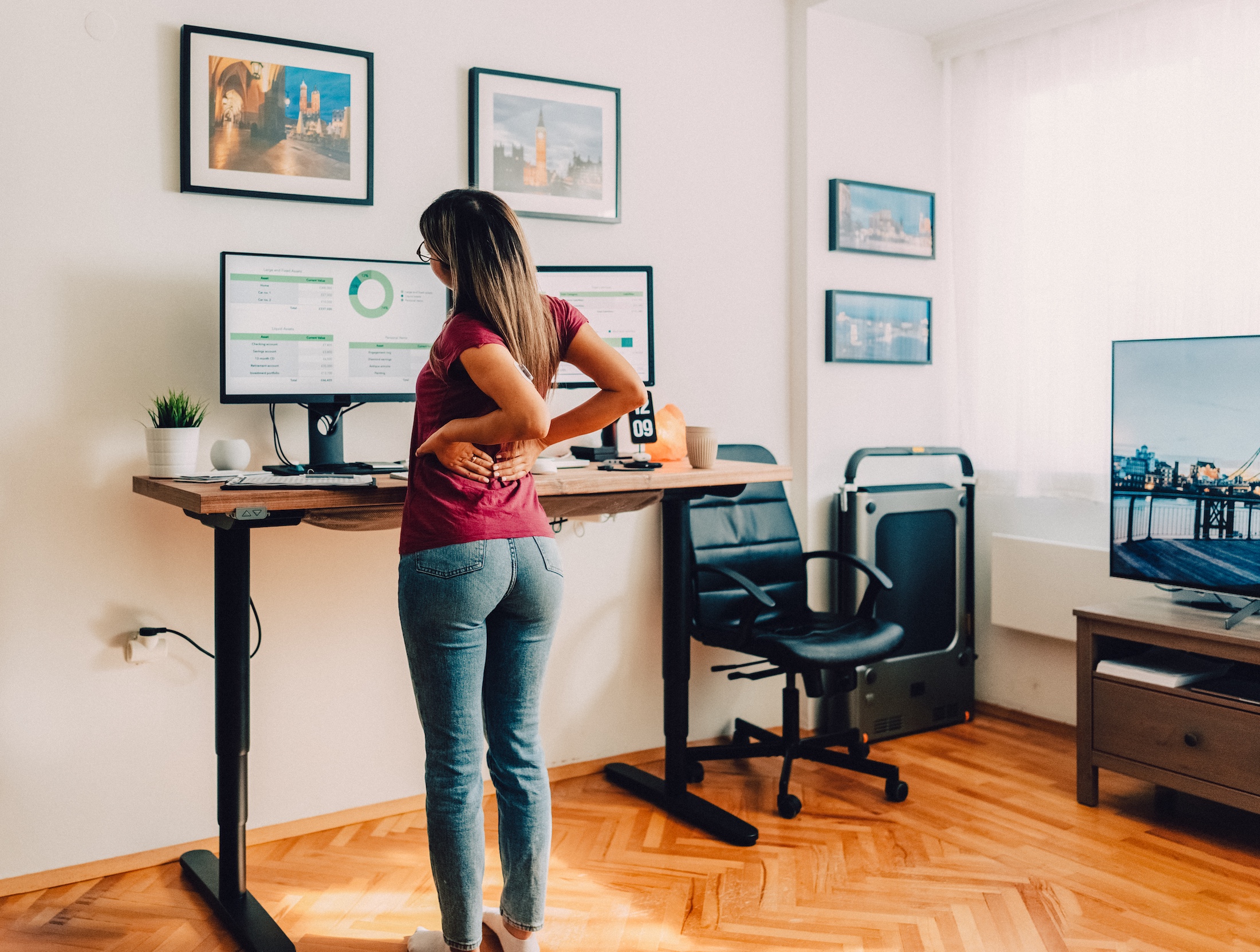 Lady standing at her desk stretching her back