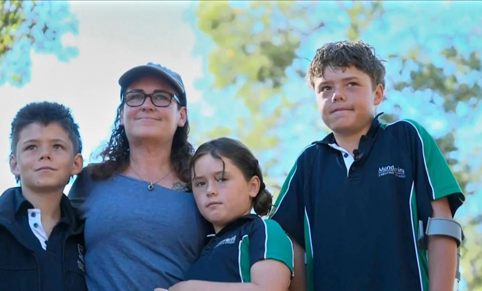 This image taken from video shows Austin Appelbee, right, posing with his family in Gidgegannup, Australia, Tuesday Feb. 3, 2026.  / Credit: ABC/AP