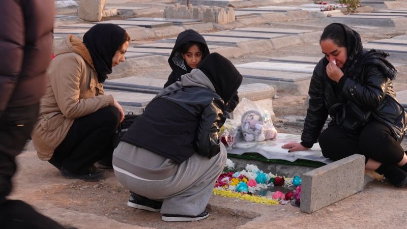  Grieving Iranians cowed into silence beside the graves of protesters