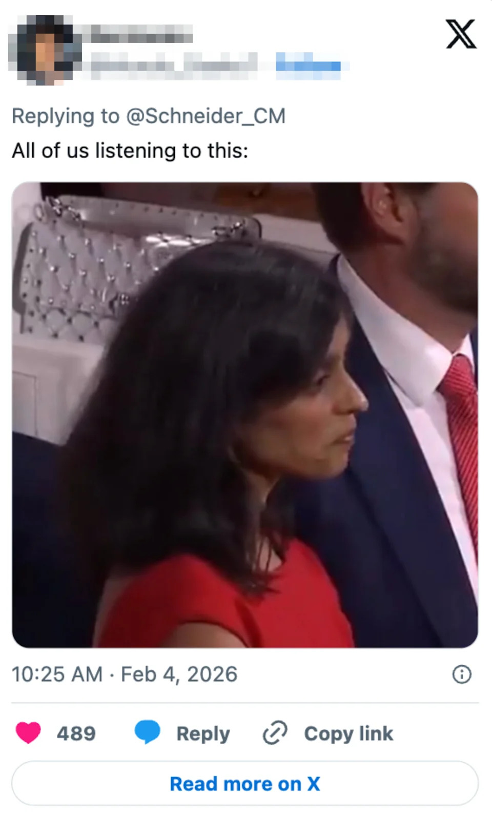 Person in formal attire listening intently during an event. Social media post captioned: "All of us listening to this."