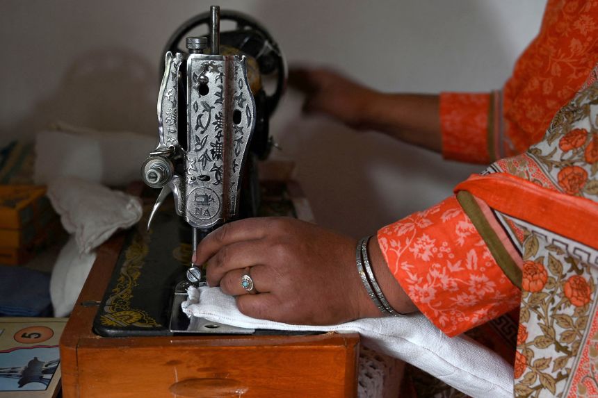 A woman makes a sanitary pad with a sewing machine in Chitral, northern Pakistan. Just 12% of women in Pakistan use commercial sanitary products, according to UNICEF.