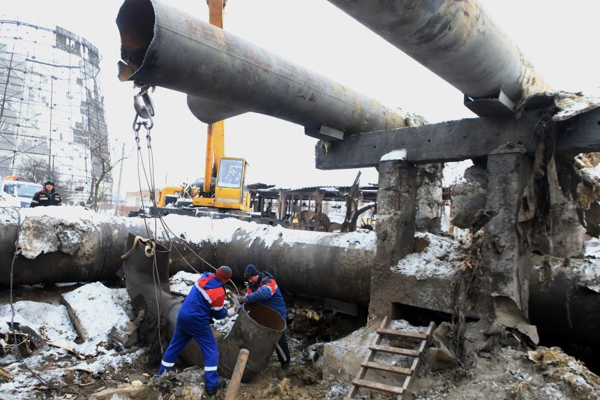 Workers prepare to lift a section of a pipe at Kyiv CHPP-4, a thermal power plant severely damaged in a massive Russian missile attack in Kyiv on the night of February 2, 2026.