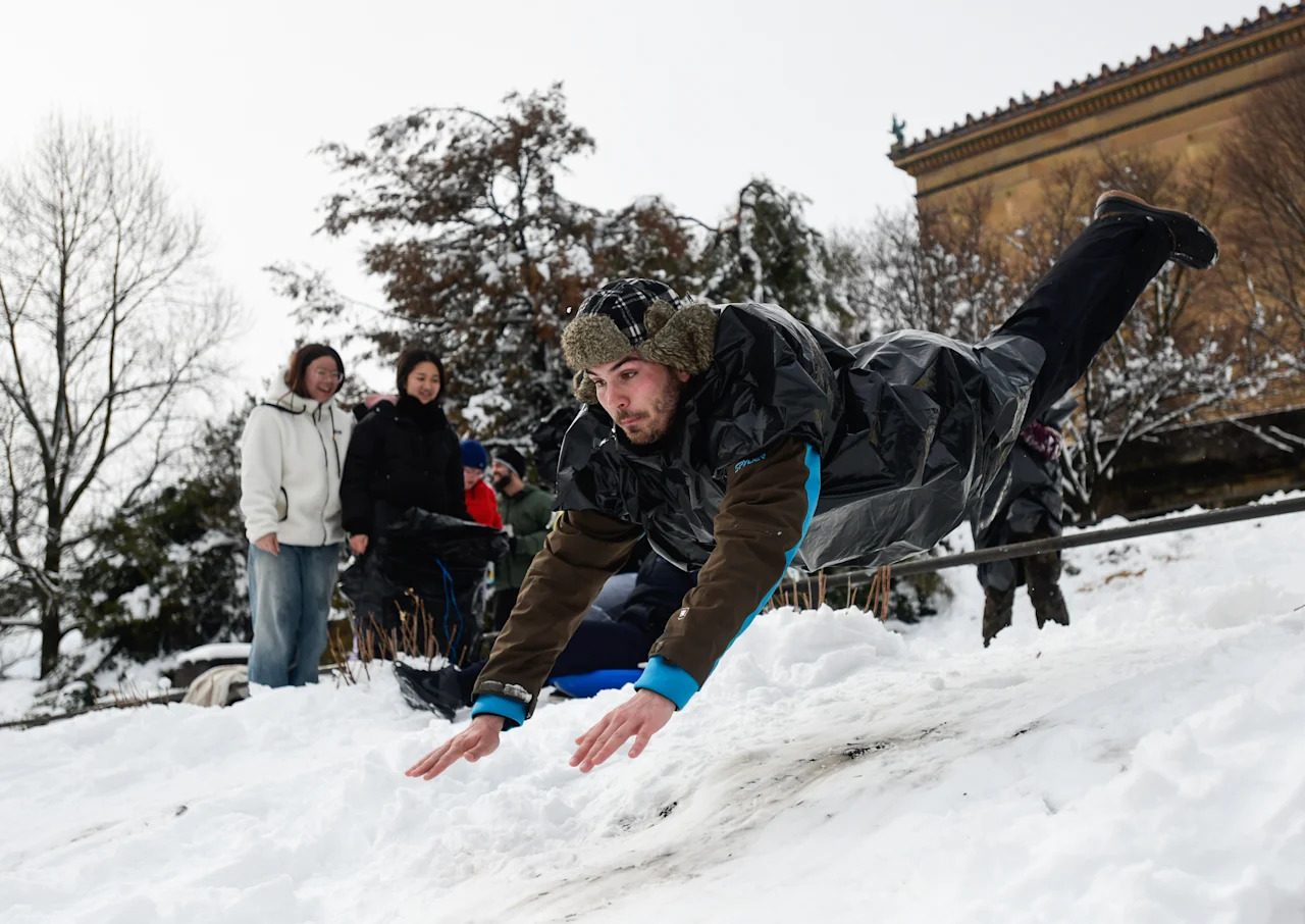 A man dives into snow.