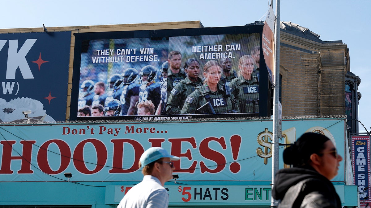 billboard says "they can't win without defense, neither can America."