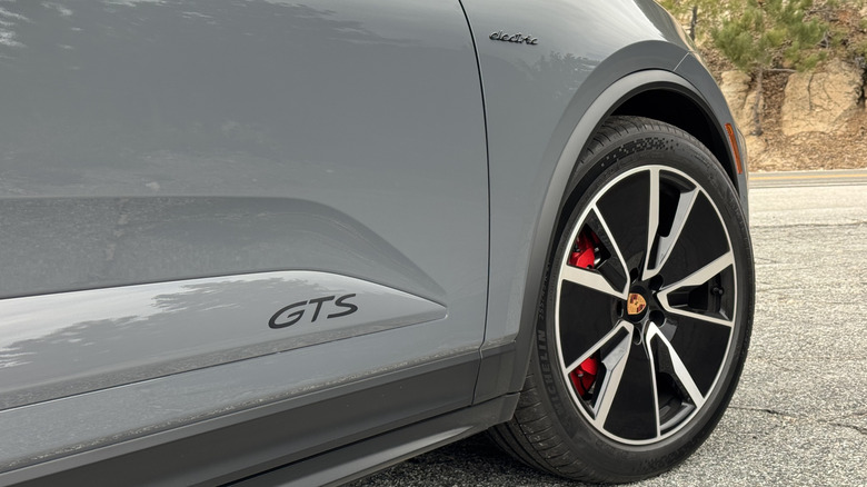 A close-up shot of the front passenger side wheel, as well as the GTS and Electric badges on the door and fender, respectively