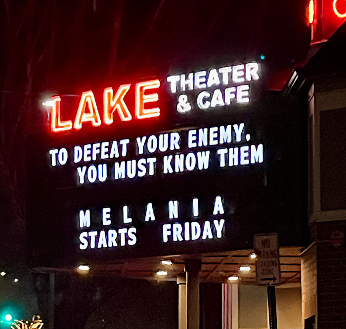 Neon sign at Lake Theater and Cafe with a witty message referencing Melania and a start date on Friday.