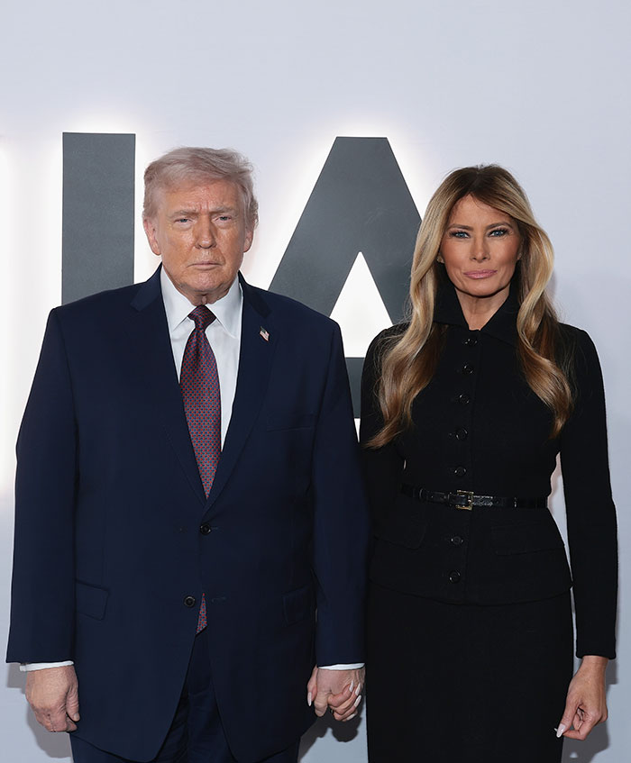 Donald Trump and Melania Trump standing together at an event, related to Melania documentary and theater's clap back.