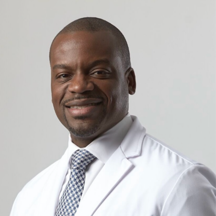 Head and shoulders of man wearing tie and a white doctor’s coat