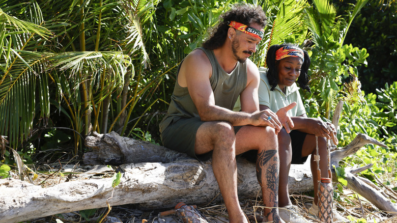 Ozzy and Cirie sitting on a log together on Survivor 50