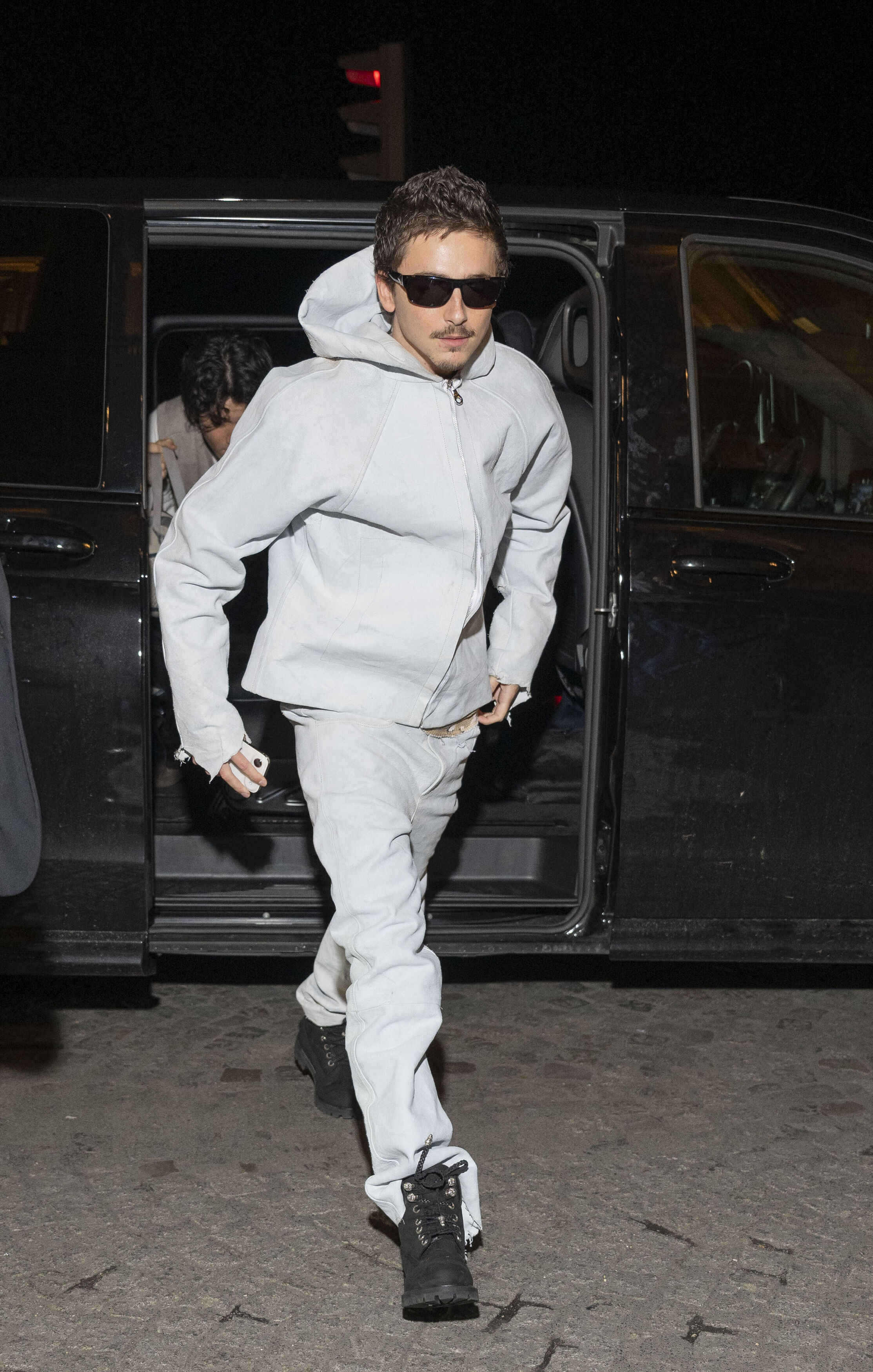Timothée Chalamet arrives at the after-party for his latest film "Marty Supreme" decked in a white sweatsuit in Paris, France.