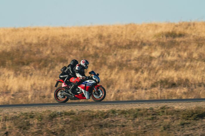 Two people riding a motorcycle on an open road, illustrating a scenario that may lead to PTSD or coma experiences.