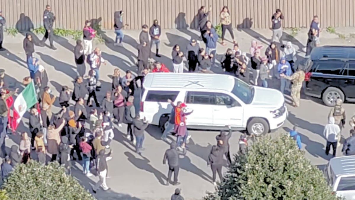 Protesters surround Border Patrol vehicles during immigration raid in Chicago’s Little Village.