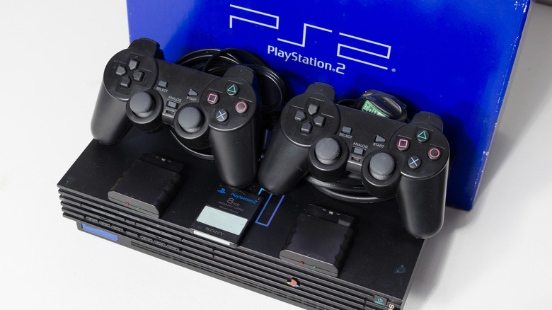 A PS2 Fat with 2 controllers, an 8 MB memory card, and 2 wireless adapters