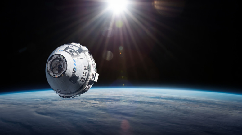 Artist's rendering of a Boeing Starliner in orbit with the Sun behind it