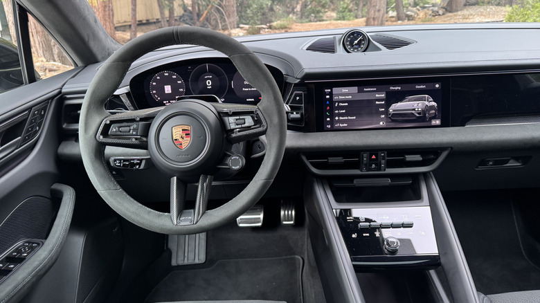 A close-up of the steering wheel and driver's POV inside the gray Macan GTS