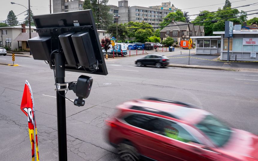 Cars pass by a Flock license plate reading camera May 15, 2025, in Eugene, Oregon. Sen. Ron Wyden of Oregon expressed privacy and security concerns with Flock cameras in a letter last October.