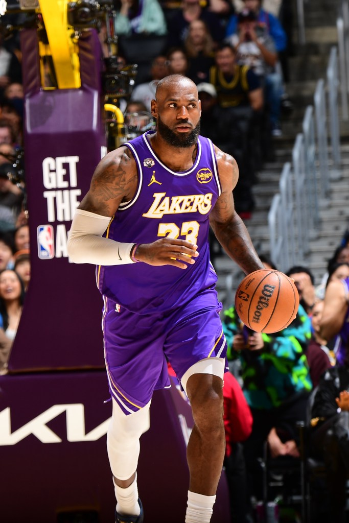LeBron James dribbling the basketball in a Lakers uniform.