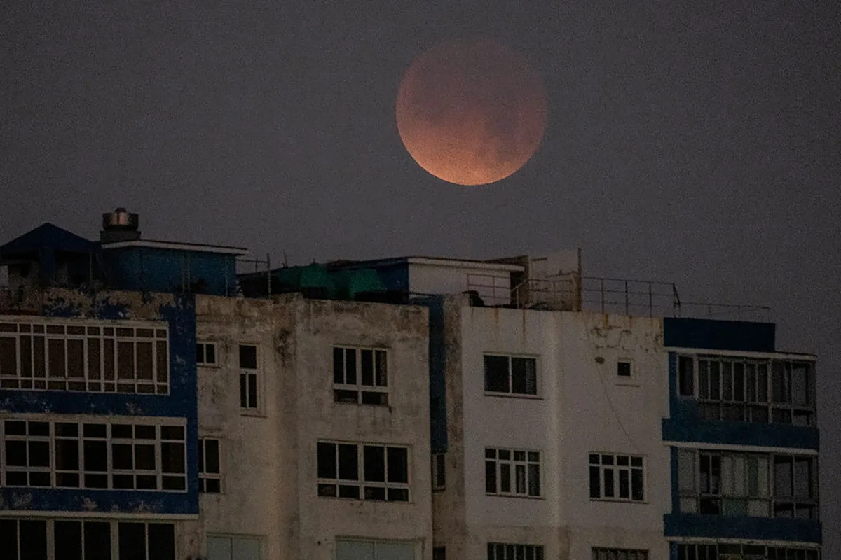 The blood M above the buildings of Havana, Cuba, on March 3, 2026, during a total lunar eclipse. Photo by YAMIL LAGE / AFP via Getty Images